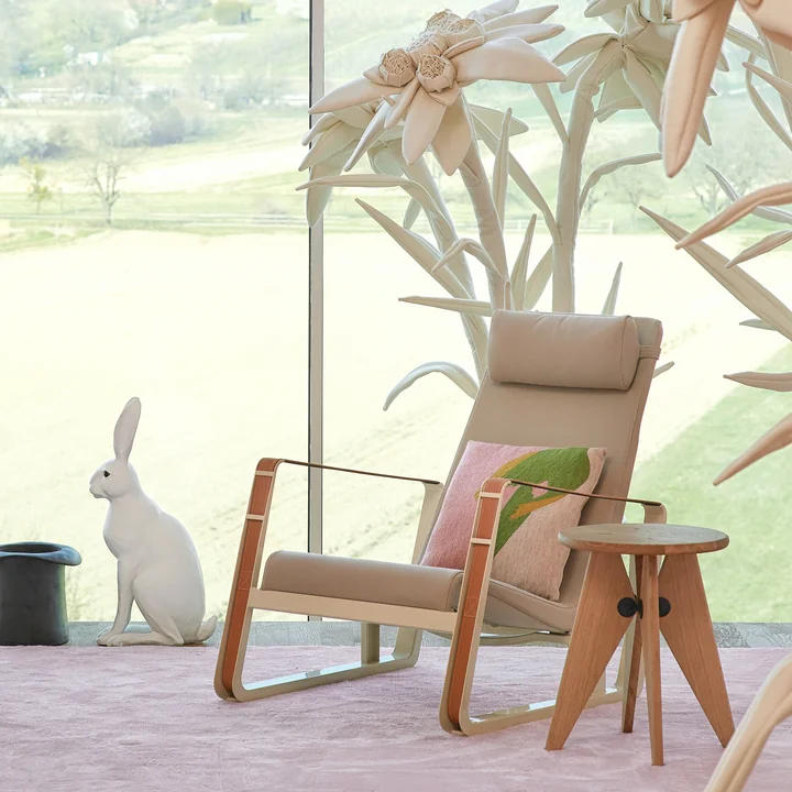 Le fauteuil Cité de Vitra, revêtement beige (Cité 01), piètement écru / sangle en cuir cognac