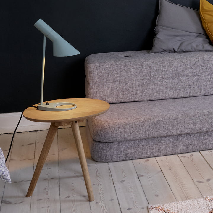 La lampe de table AJ de Louis Poulsen sur une table d'appoint dans le salon