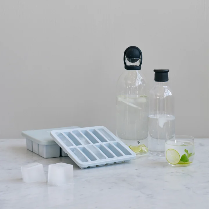 La machine à glaçons avec couvercle Freeze-It de Rig-Tig by Stelton avec des carafes en verre sur la table