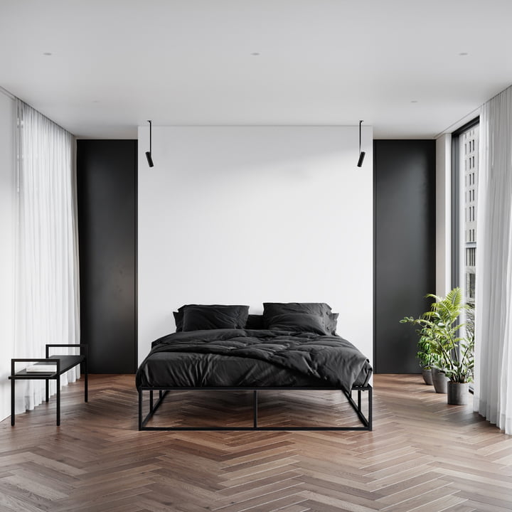 Le banc de Nichba Design dans une chambre à coucher minimaliste en noir et blanc