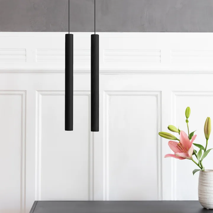 Le site Chimes Suspension LED de Umage en noir devant un mur en bois blanc