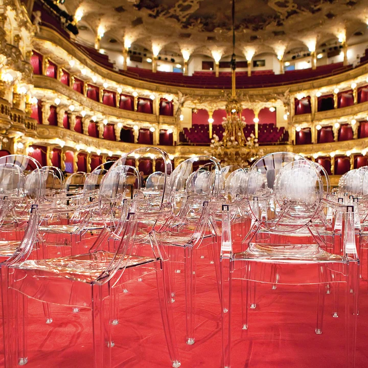 Les transparents Louis Ghost chaises de Kartell dans une grande salle d'opéra
