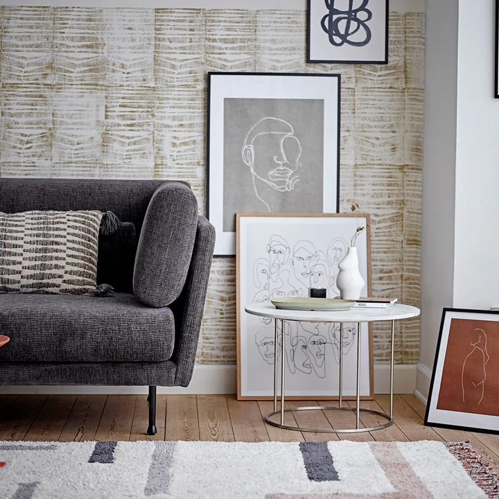 Le vase Elora de Bloomingville sur une table à côté du canapé