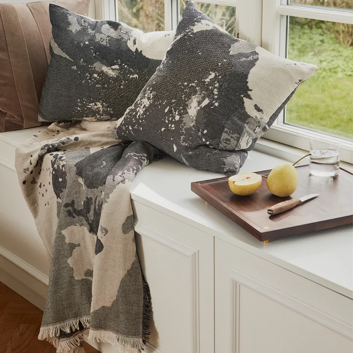 Le coussin Floreo & Plaid de AYTM dans un coin salon élégant